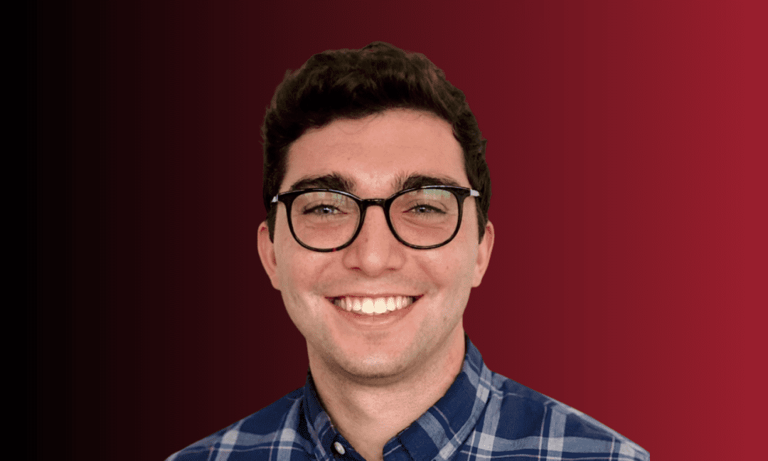 Josh Moskovitz in front of a black-to-red gradient background.
