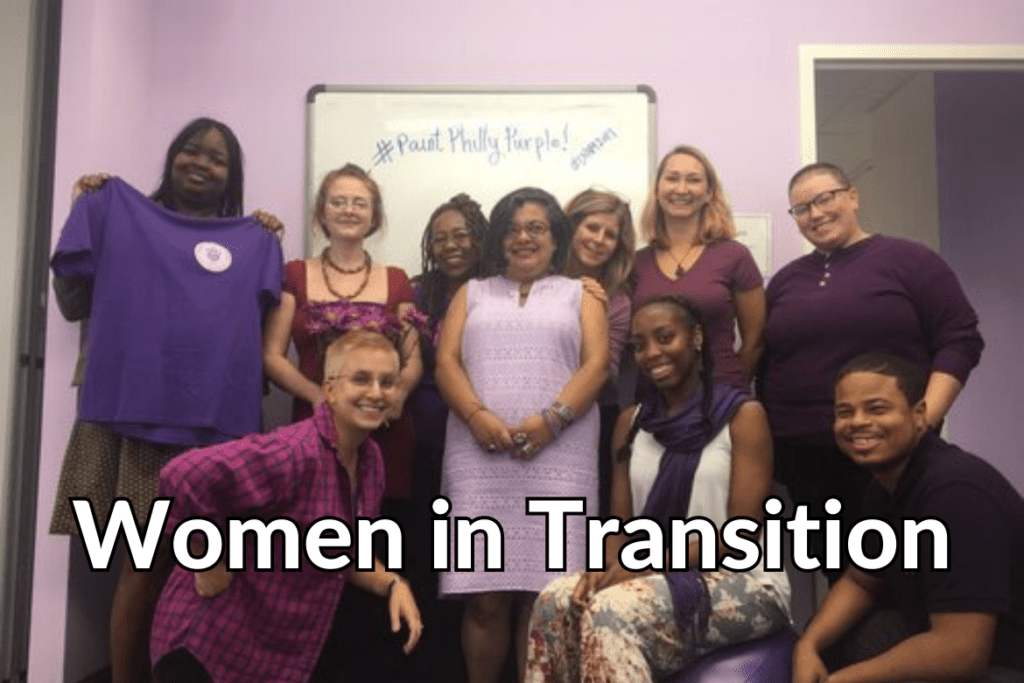 Dressed in purple, the Women in Transition staff pose for a photo
